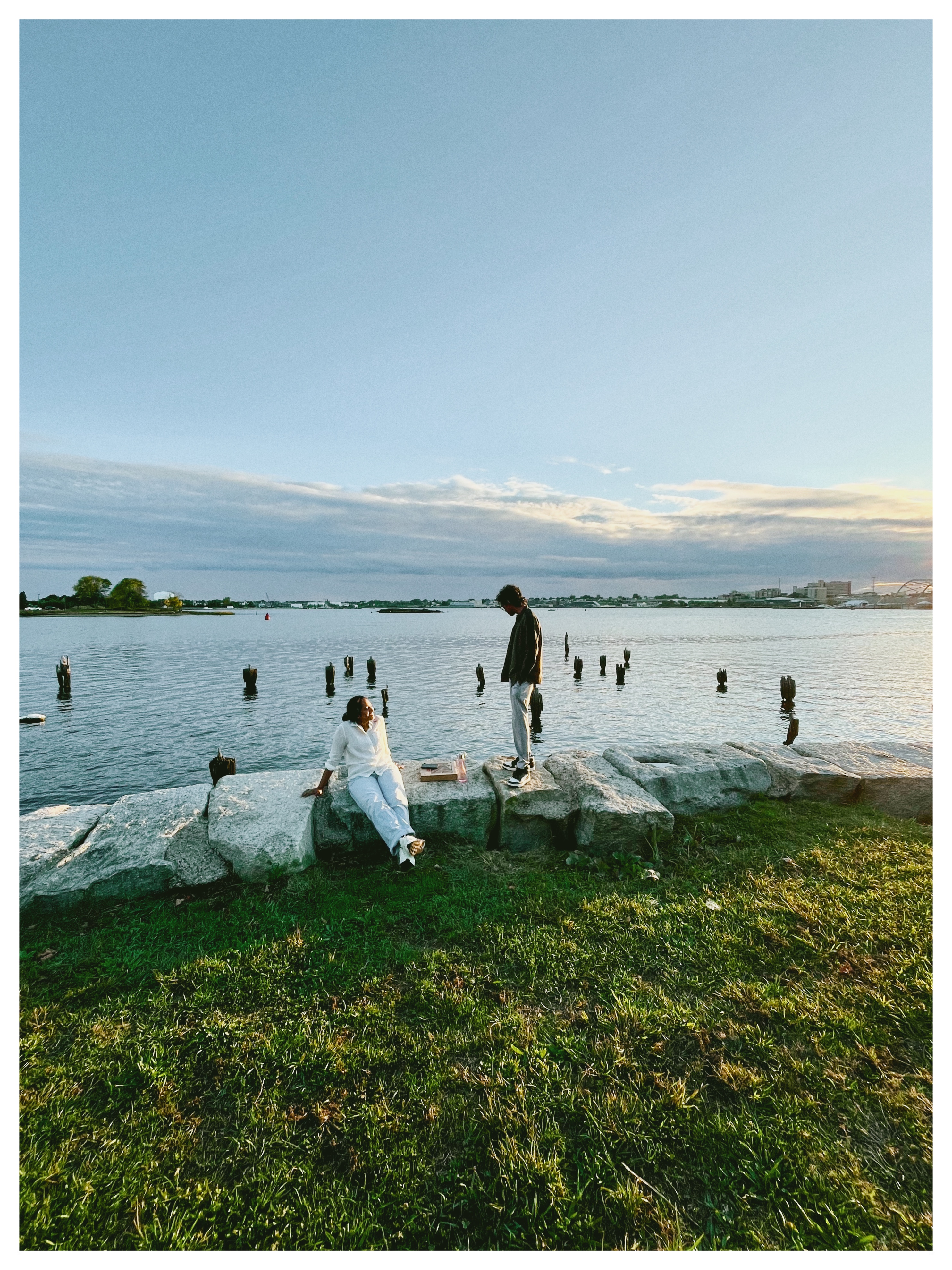 Two people on the rocks at the waterfront