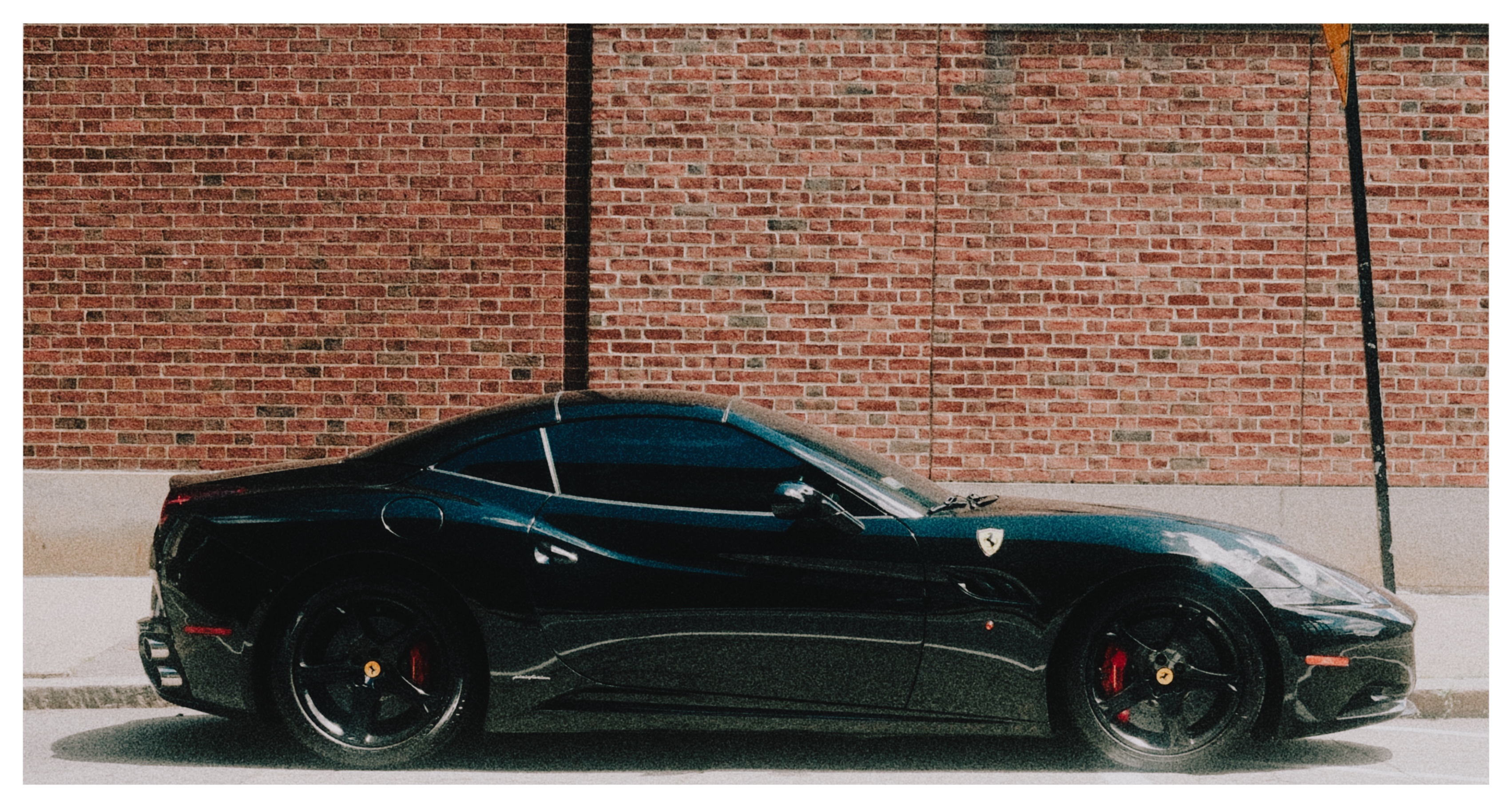Parked against a brick wall