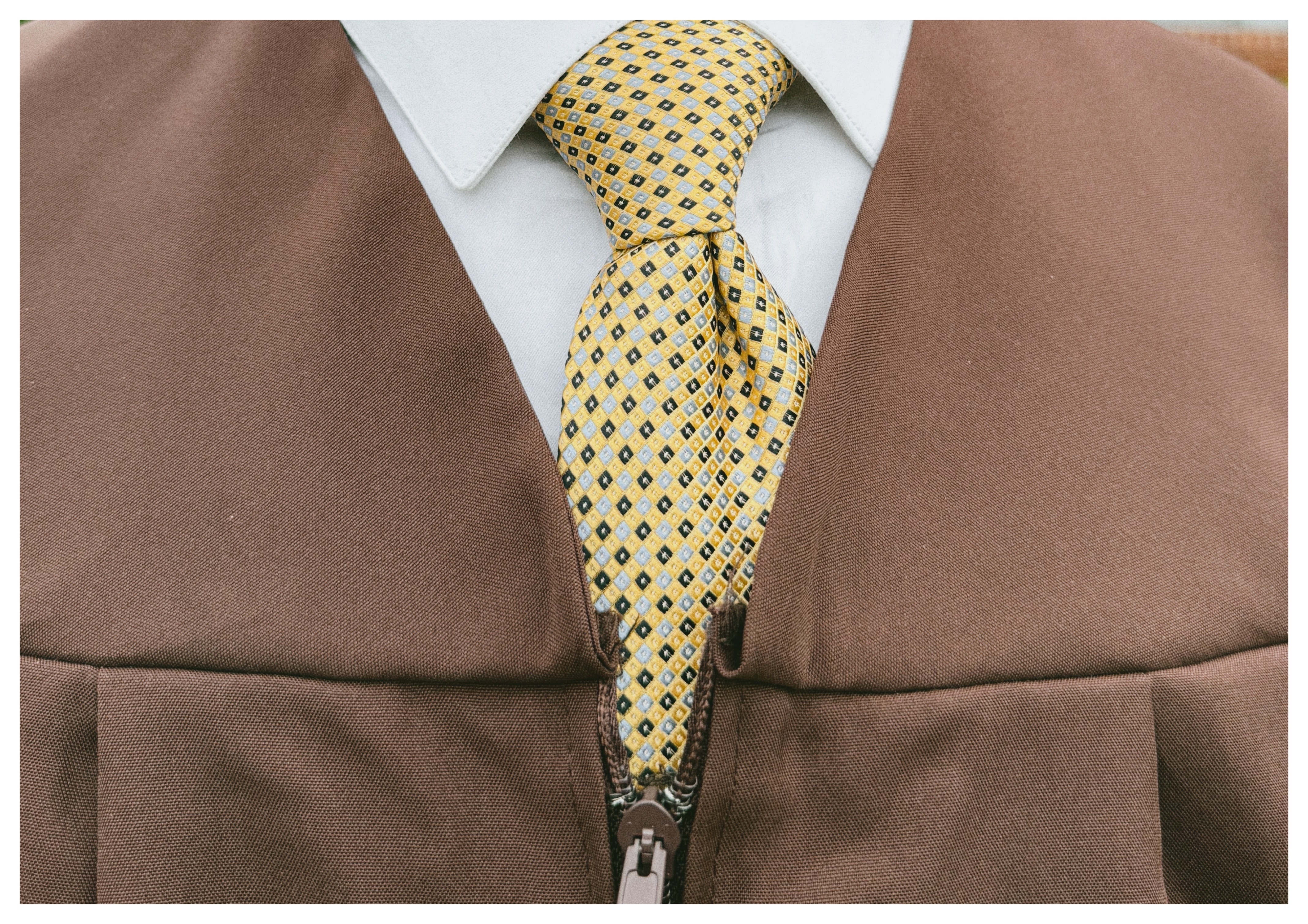 Brown jacket, yellow tie